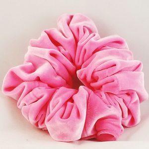 Jumbo neon pink velvet scrunchy on a white background. The scrunchy is made of soft velvet fabric and has a large size that can accommodate thick hair. The vibrant pink color adds a pop of color to any hairstyle