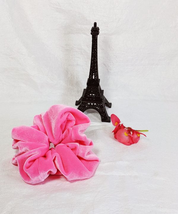 Large neon pink scrunchy on a white background. The scrunchy is made of soft fabric and has a size that is perfect for creating full buns or half-up styles. The bright pink color adds a bold touch to any hairstyle.